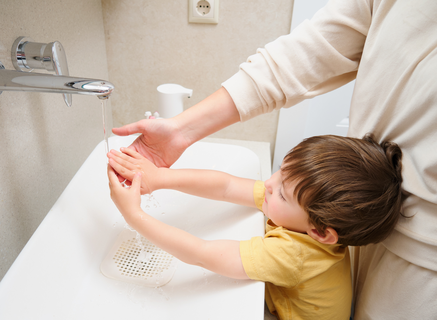 Parent and child washing their hands